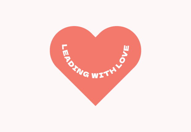 Coral red heart with "Leading With Love" in a half circle inside it, all on a pastel red background.
